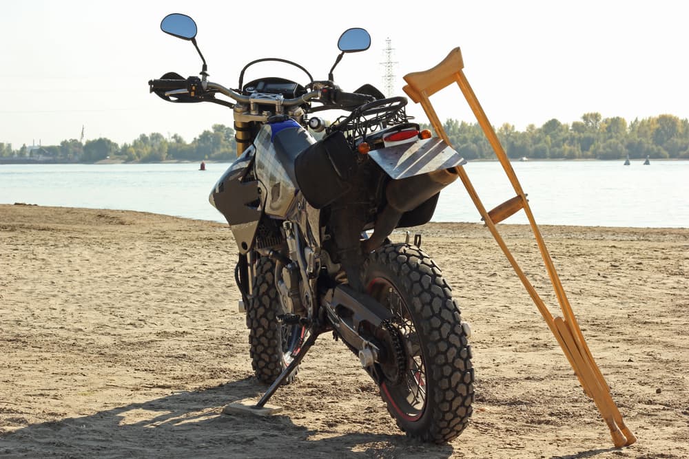 Motorcycle and crutches on the beach